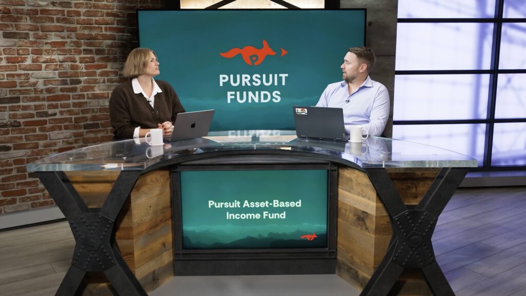 Seth Lowry, CFA and Liz Marie, CAIA, cofounders of Pursuit Funds, sit at a news desk discussing niche asset-based lending